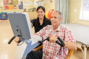 A physical therapist helping a man do therapy