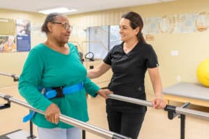 A nurse helping a woman to walk