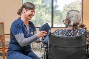 A nurse taking an elderly woman's blood pressure