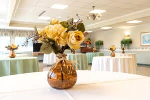A flower bouquet at the top of a table in the dining room