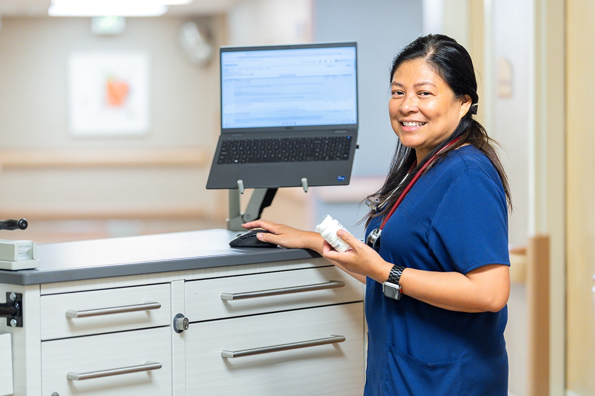 A nurse looking at a computer at Hemet Hills